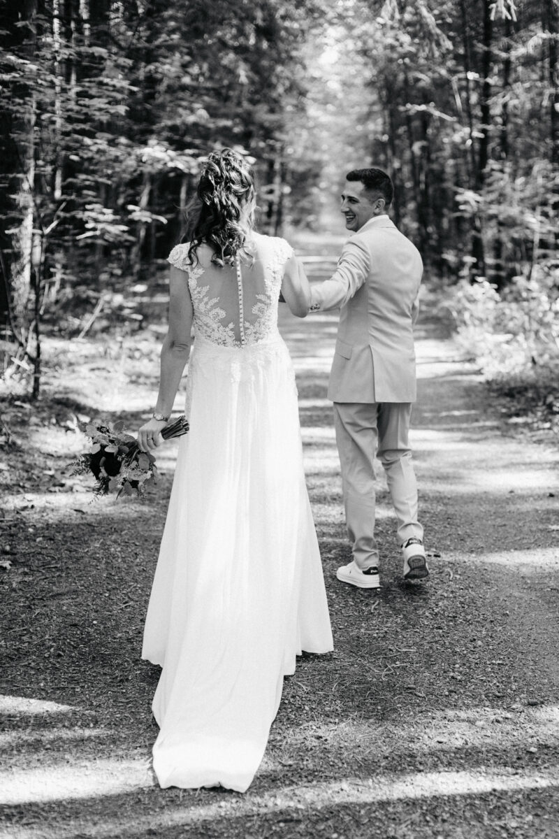 Brautpaar geht auf einem Waldweg am Filzenklas